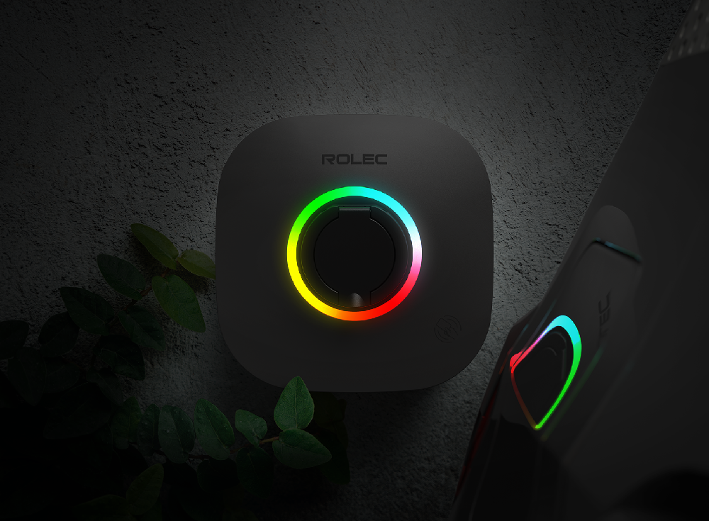 Rolec EVO 7.4kW EV charger glowing multi-coloured LED ring at night – weatherproof wall-mounted design